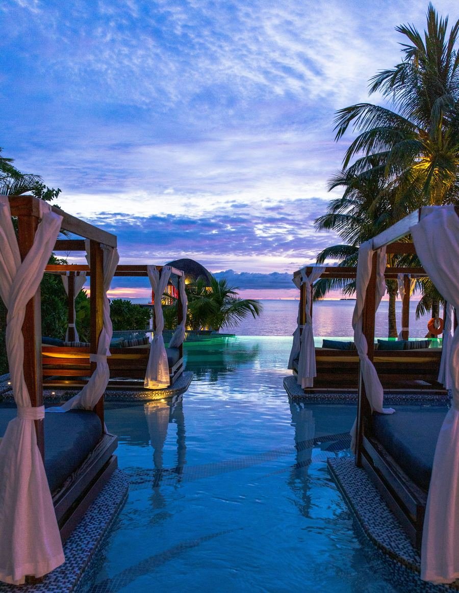 Luxury resort infinity pool at sunset